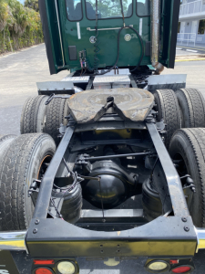 Peterbilt 579 chassis and rear view showing dual rear axles and fifth wheel with frame components visible.