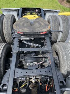 Truck chassis view showing center area with wiring, frame, and rear axle assembly for a 2018 Peterbilt 579 day cab.