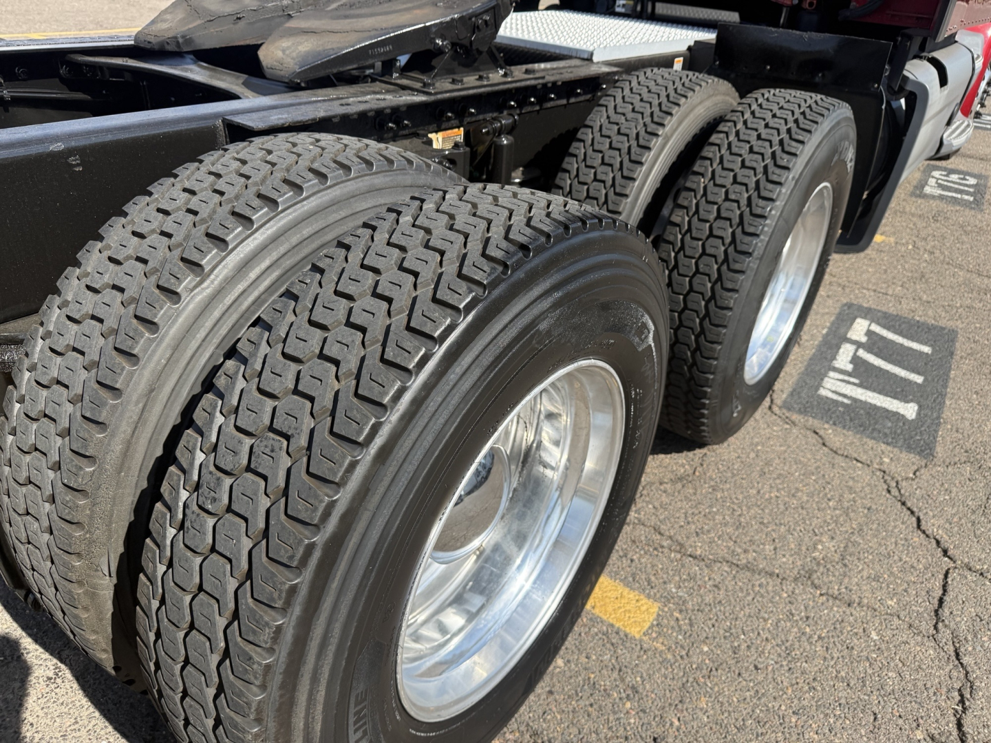 Peterbilt 579 truck rear dual axles with heavy-duty tires and polished rims, undercarriage visible