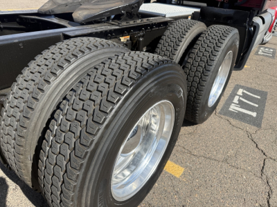 Peterbilt 579 truck rear dual axles with heavy-duty tires and polished rims, undercarriage visible