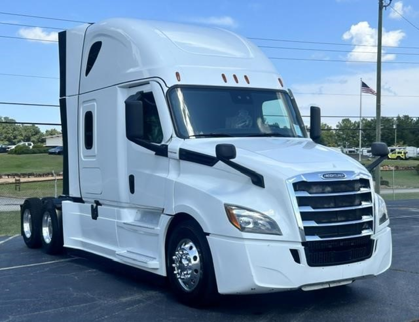 Freightliner Cascadia 126 sleeper cab tractor truck in white, front-right view