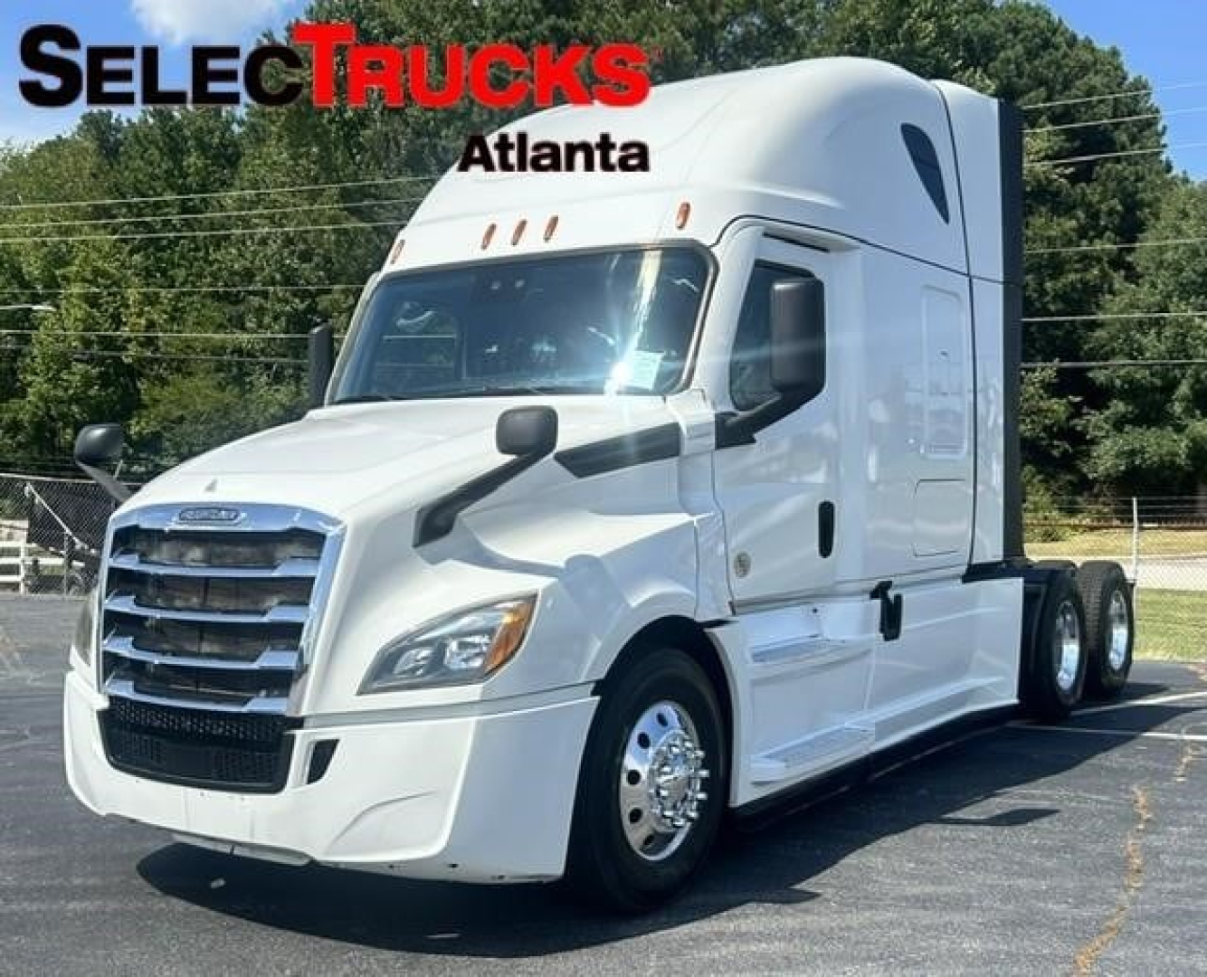 Freightliner Cascadia 126 truck side view showing cab and chrome wheel rims with SelectTrucks Atlanta logo