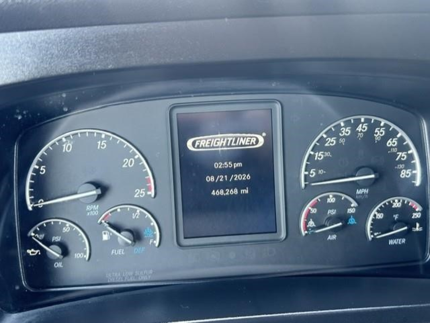 Dashboard of a Freightliner Cascadia showing center display with time and mileage 468,268 mi, left tachometer and fuel/oil gauges, right speedometer and engine indicators.