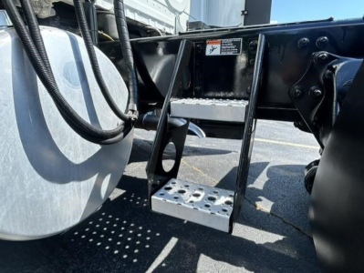 Freightliner Cascadia 126 chassis area showing steps and frame detail under cab.