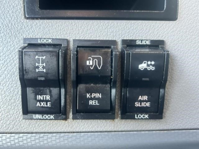 Truck interior switch panel with lock, slide, intr axle, k-pin rel, air slide icons from Freightliner Cascadia interior