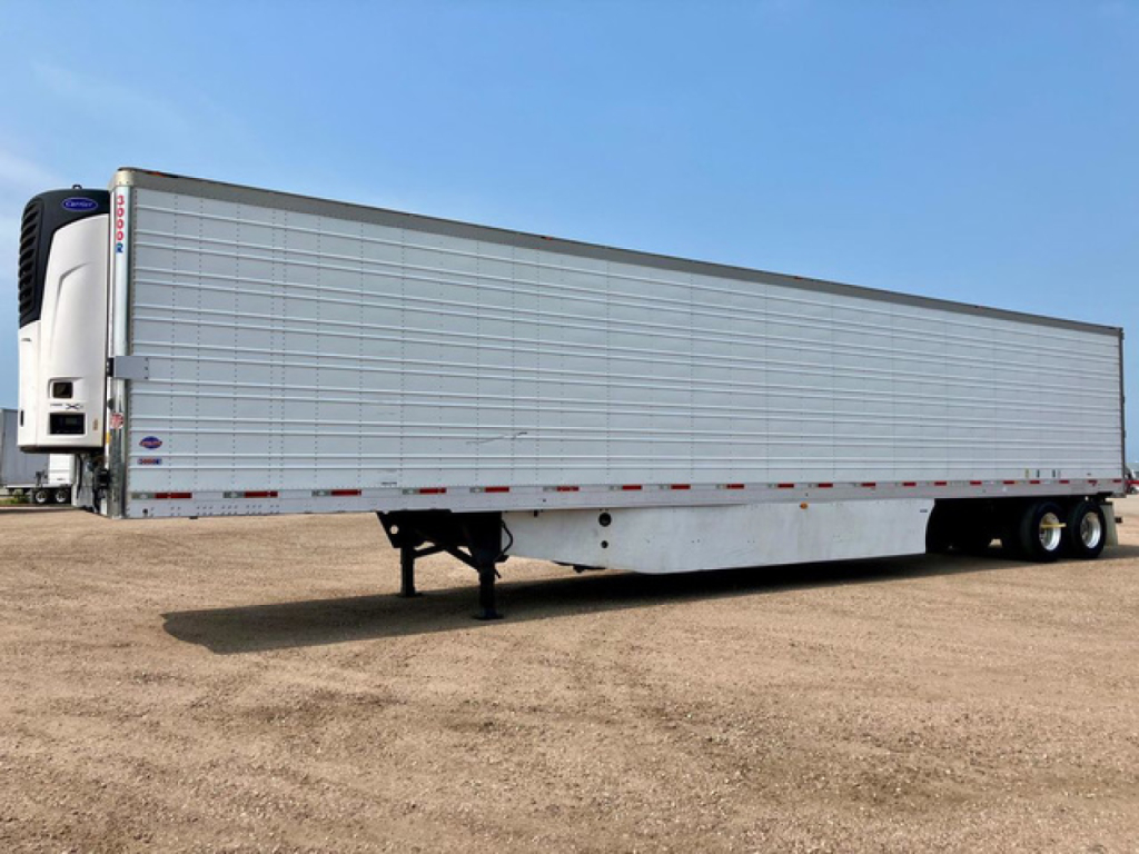 Trailer side view of a 2017 utility reefer refrigerated trailer with silver aluminum siding and a white front unit.