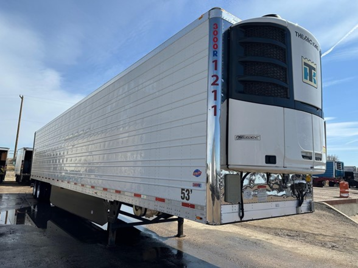 Utility 3000R refrigerated trailer showing front refrigeration unit and side panels, 53' length, metal exterior, white with blue accents.