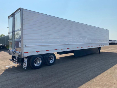 Trailer showing a refrigerated Utility trailer with dual rear axles and silver side panels. Visible markings include a small sign near the rear with the number 25 and a door at the back; the side has horizontal lines and a reflective strip 