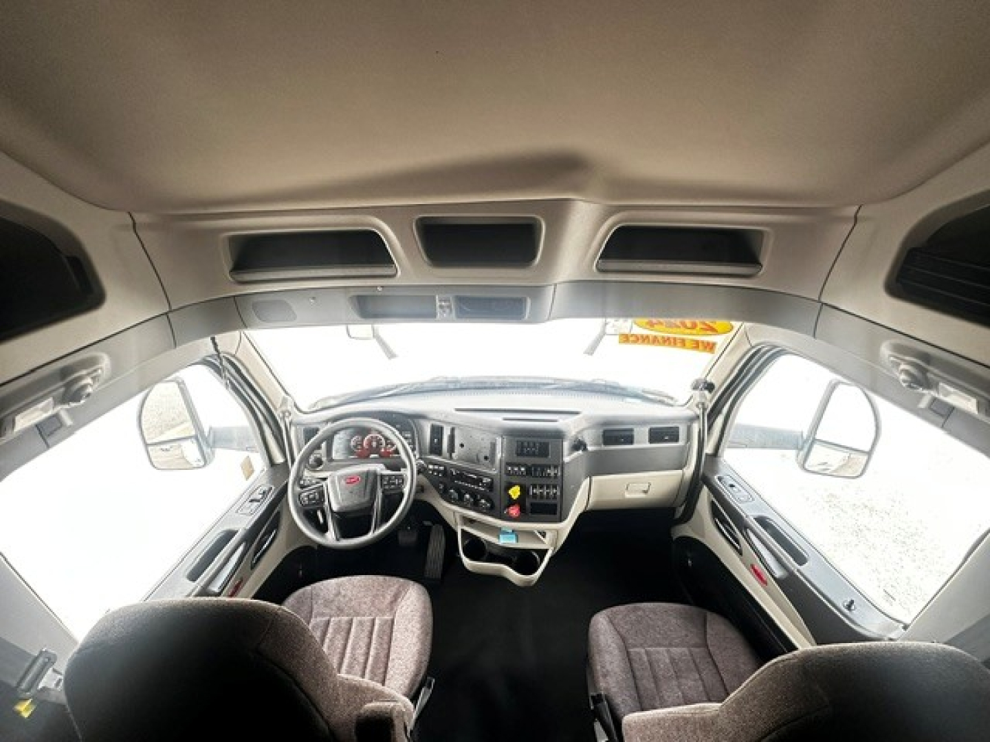 Peterbilt 579 truck interior cockpit view showing steering wheel, dashboard, and front seats.