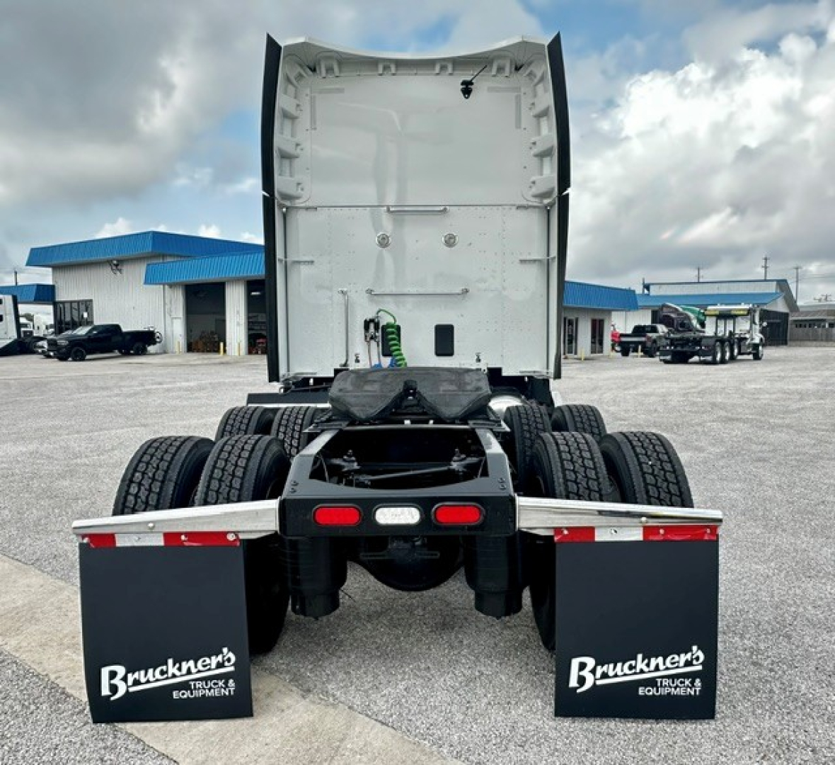 Truck rear view showing fifth wheel area and dual rear axles with mud flaps reading Bruckner's Truck & Equipment.