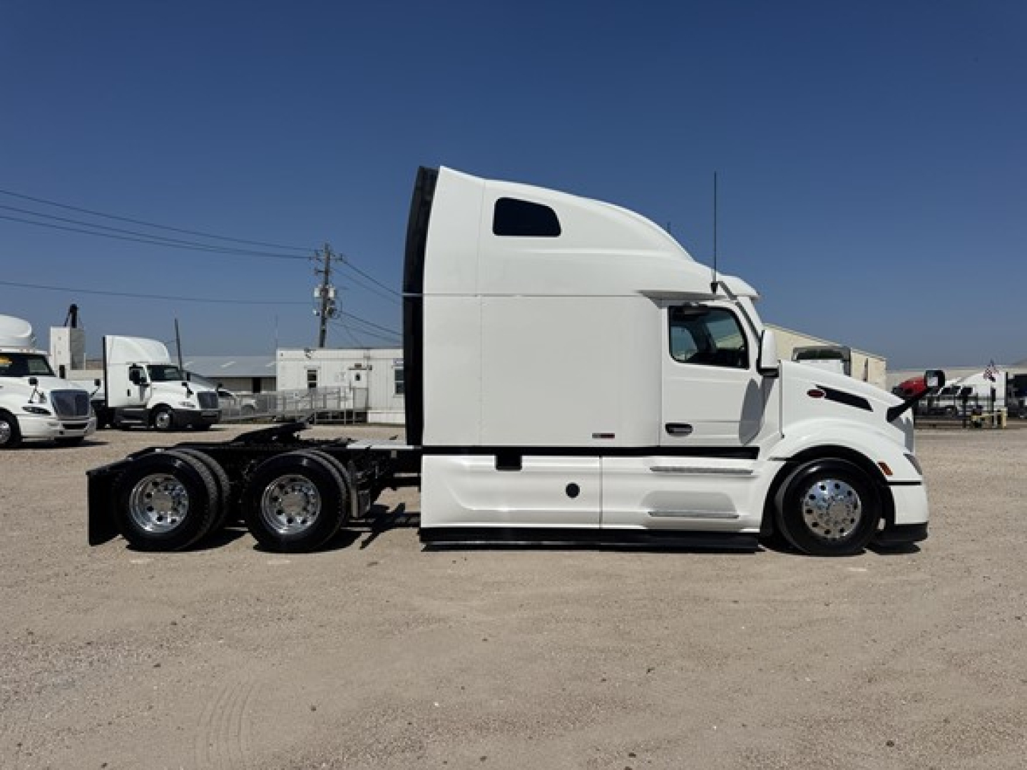 Peterbilt 579 tractor truck side view showing sleeper cab and chassis with multiple axles.