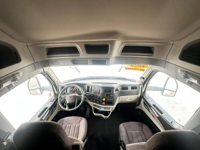 Peterbilt 579 truck interior cockpit view showing steering wheel, dashboard, and front seats.