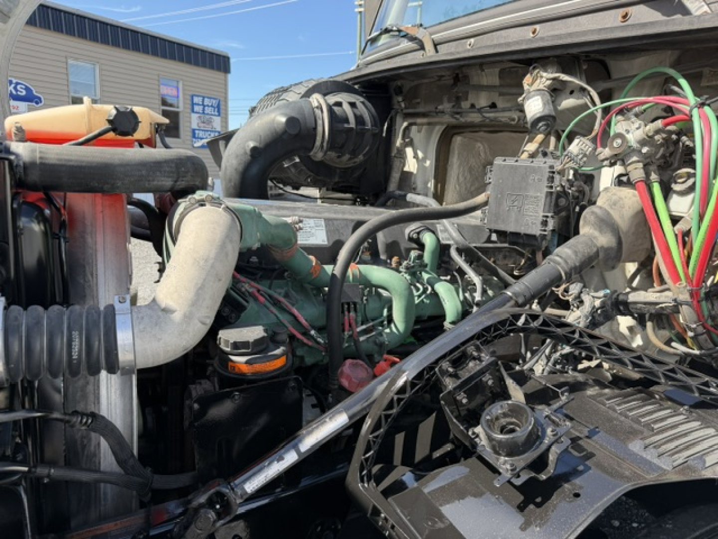 Volvo VNL64T300 engine bay shown with hoses, wiring, and components visible in the front area.