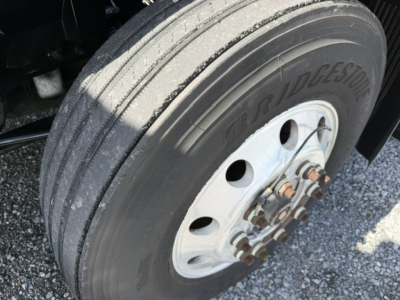 Bridgestone tire on a Volvo VNL truck showing dual rear wheels and wheel hub with lug nuts.