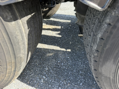 Wheel area of a 2016 Volvo VNL64T300 truck showing dual rear tires and undercarriage components.