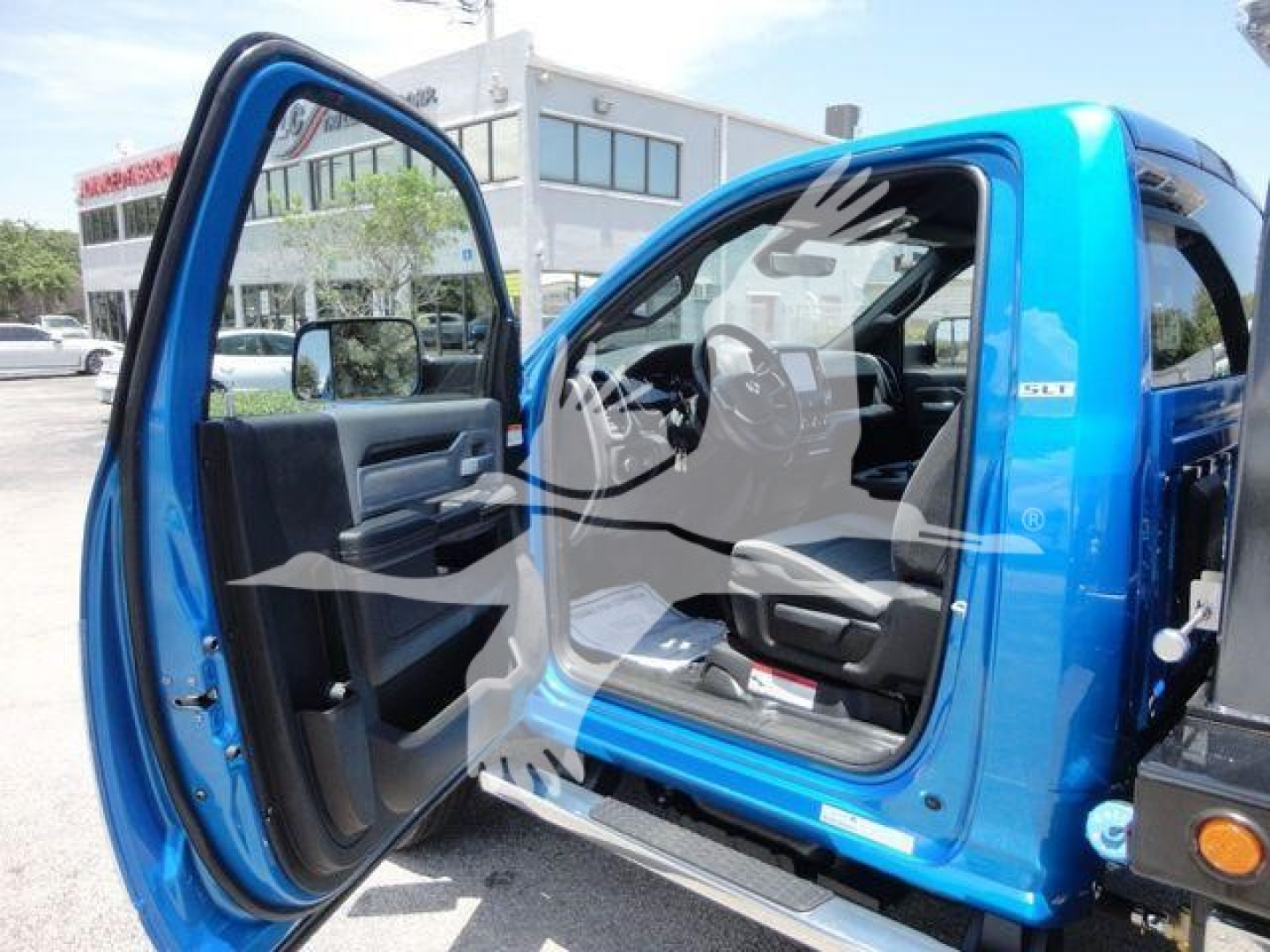 Ram 5500 truck cab interior visible with door open, blue exterior, dashboard and driver seat in view.