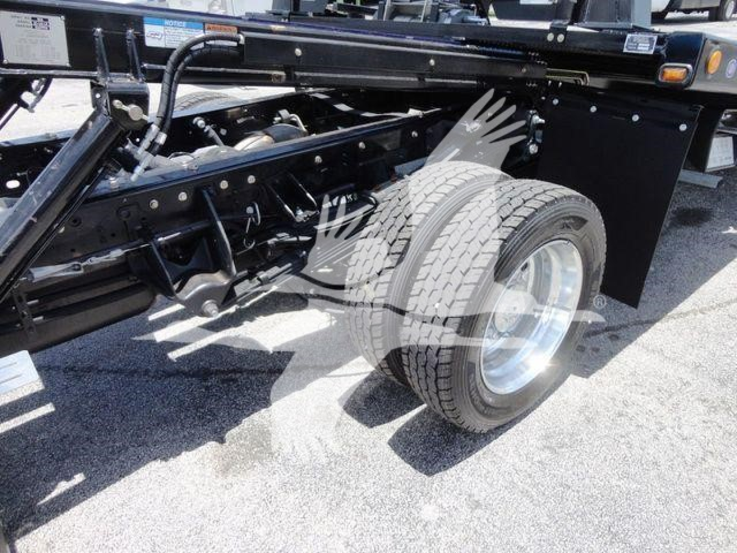 Ram 5500 chassis with dual rear wheels and suspension components visible; wheel, tire, and frame undercarriage area.