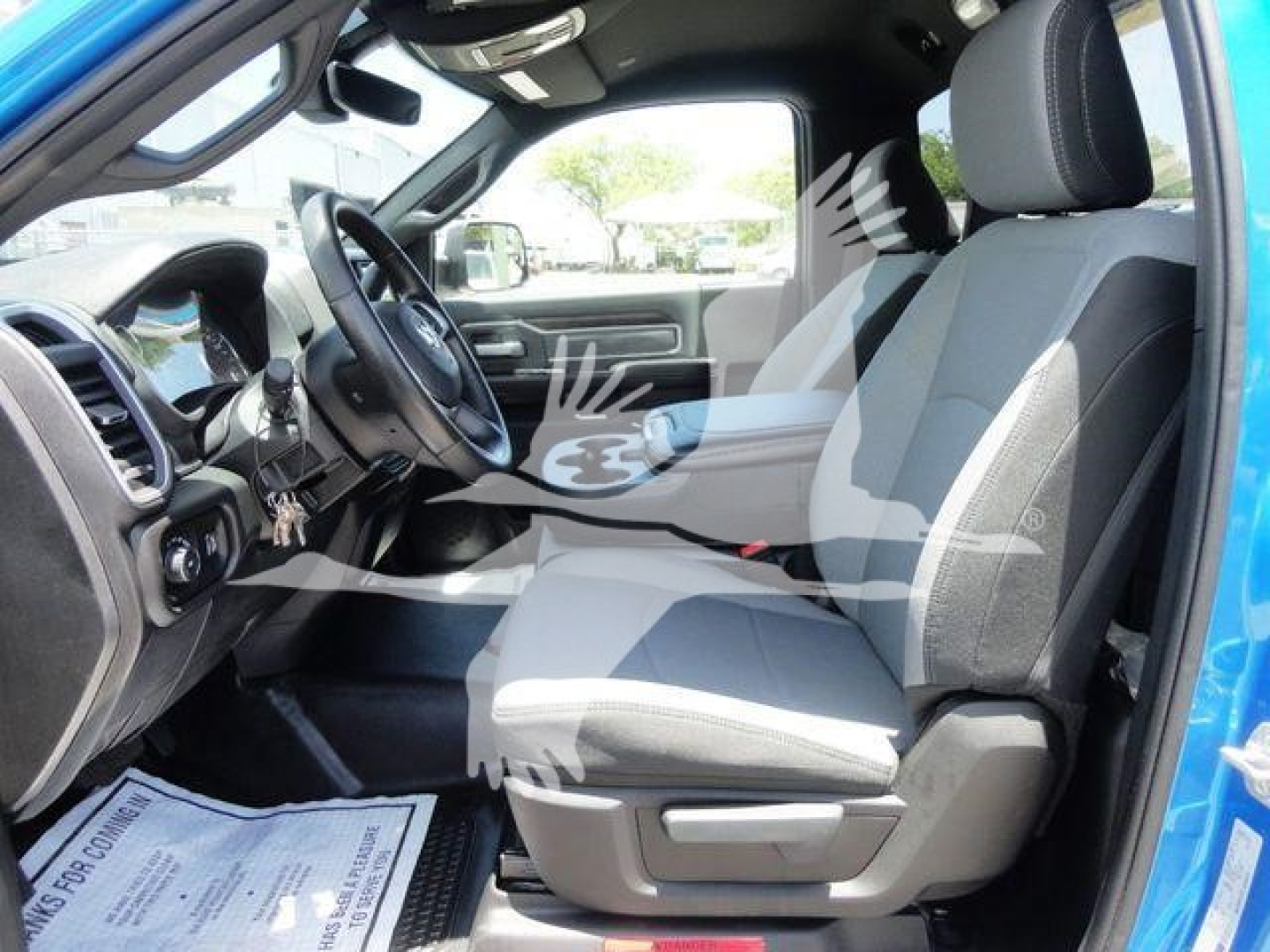 Ram 5500 SLT interior front seats showing steering wheel and dashboard with gray cloth seats.