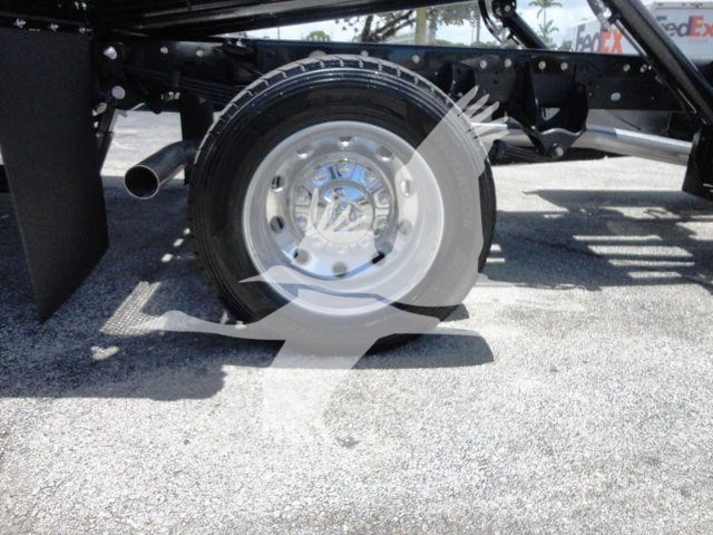 Ram 5500 SLT truck wheel showing aluminum hubcap and tire on rollback chassis.