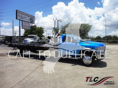 2024 Ram 5500 SLT tow truck on flatbed rollback trailer with TLC Truck & Equipment logo watermark.