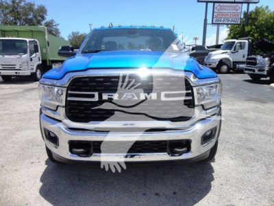 Front view of a blue 2024 Ram 5500 SLT pickup truck showing chrome grille and bumper with RAM emblem.