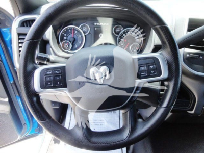 Ram steering wheel and instrument cluster inside a Ram 5500 SLT, with dashboard controls visible.