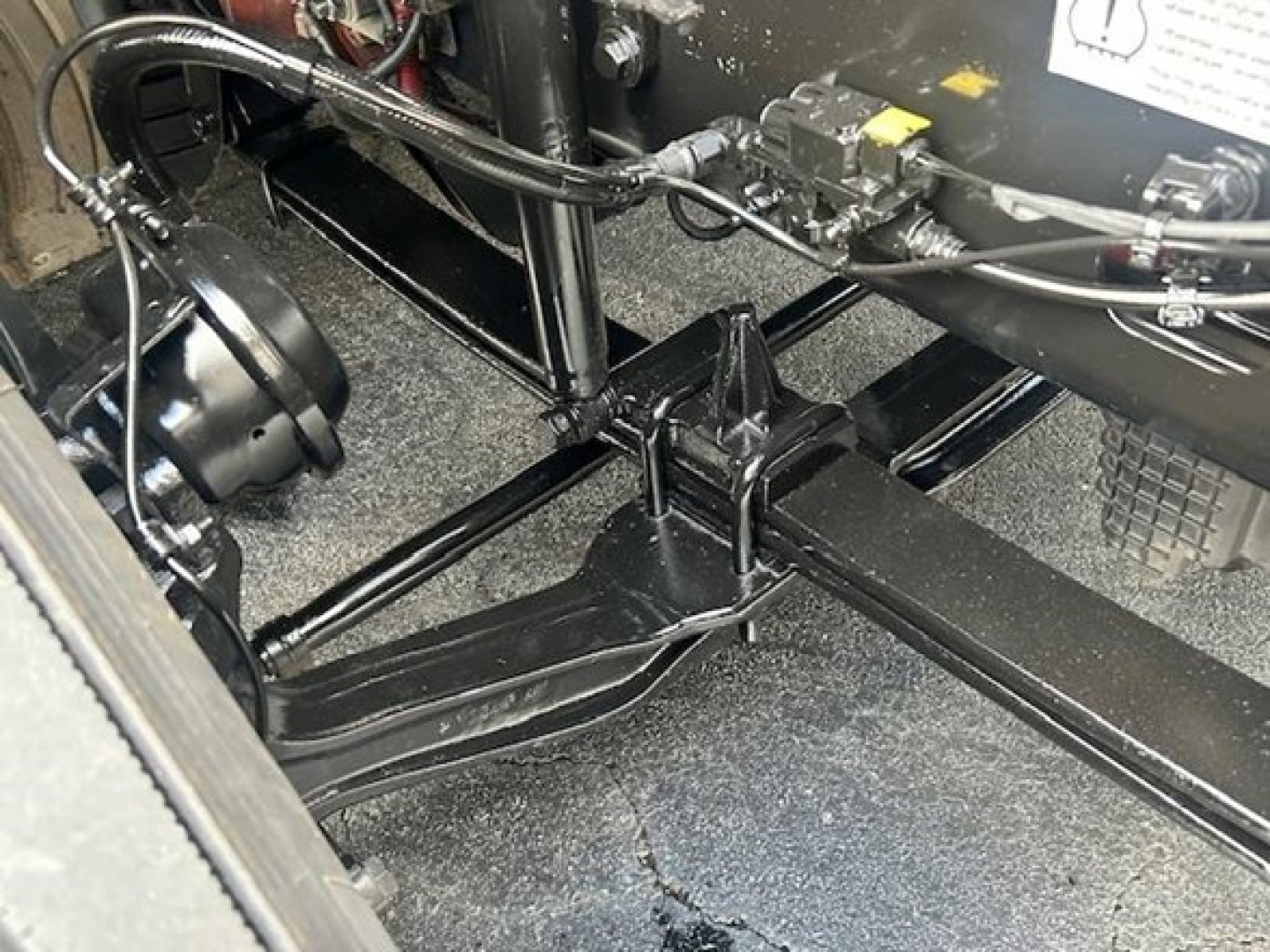 Chassis area of a Freightliner Cascadia 126 truck showing the frame rails, suspension components, and part of the engine bay; no readable labels visible.