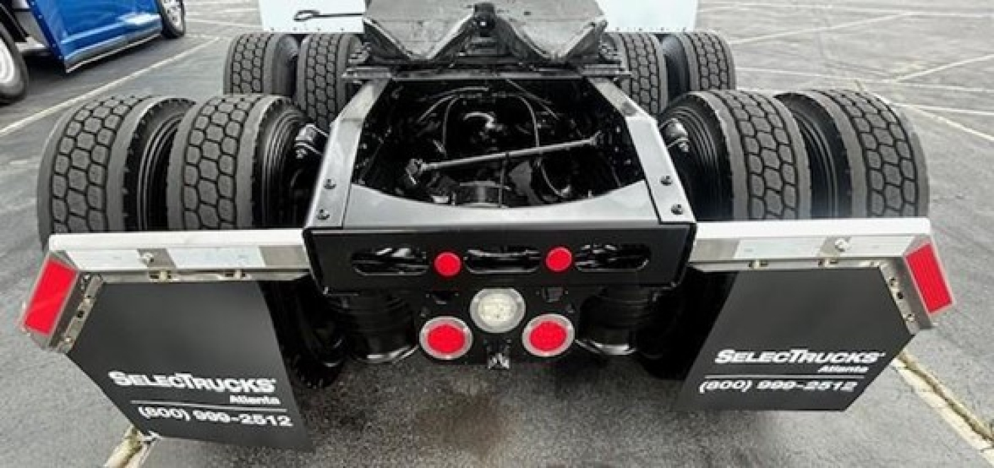 Freightliner Cascadia 126 rear view showing dual rear axles and chassis detailing with mud flaps.