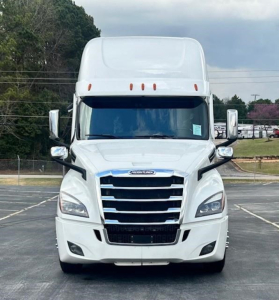 Front view of a white 2023 Freightliner Cascadia 126 sleeper tractor showing bold grille and headlights.