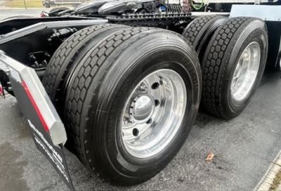 Rear dual-axle truck wheels and tires showing chrome rims and tread pattern.