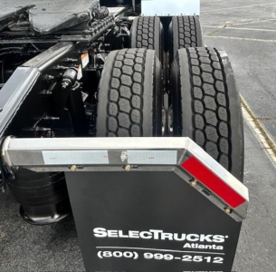 Rear view of a Freightliner Cascadia truck showing tandem rear axles and mudflap with SelectTrucks Atlanta contact info.