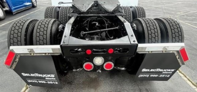 Freightliner Cascadia 126 rear view showing dual rear axles and chassis detailing with mud flaps.