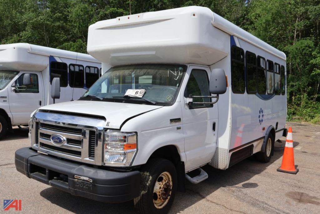 Ford E-350/N-1 wheelchair bus in a used condition showing front and passenger side with orange cone nearby.