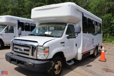 Ford E-350/N-1 wheelchair bus in a used condition showing front and passenger side with orange cone nearby.