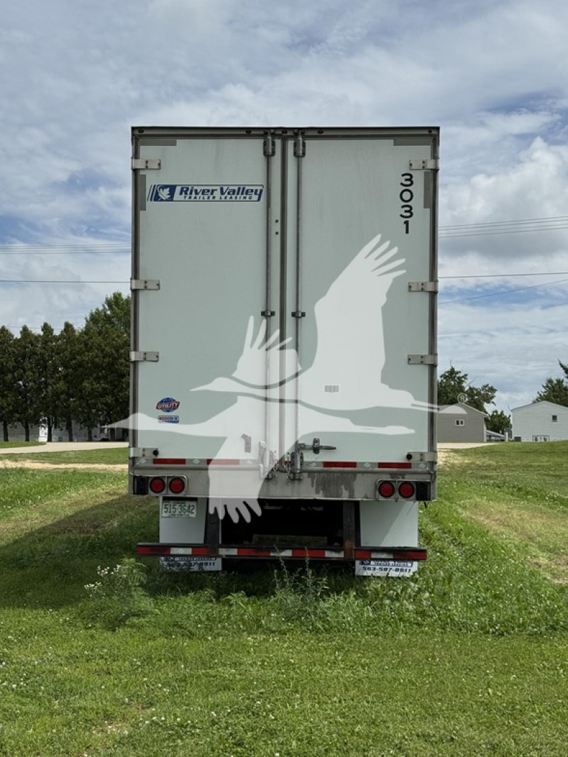 Rear view of a 2023 Utility 4000D-X trailer showing River Valley Transportation sticker, vertical 3031 number, and twin doors with latching handles.