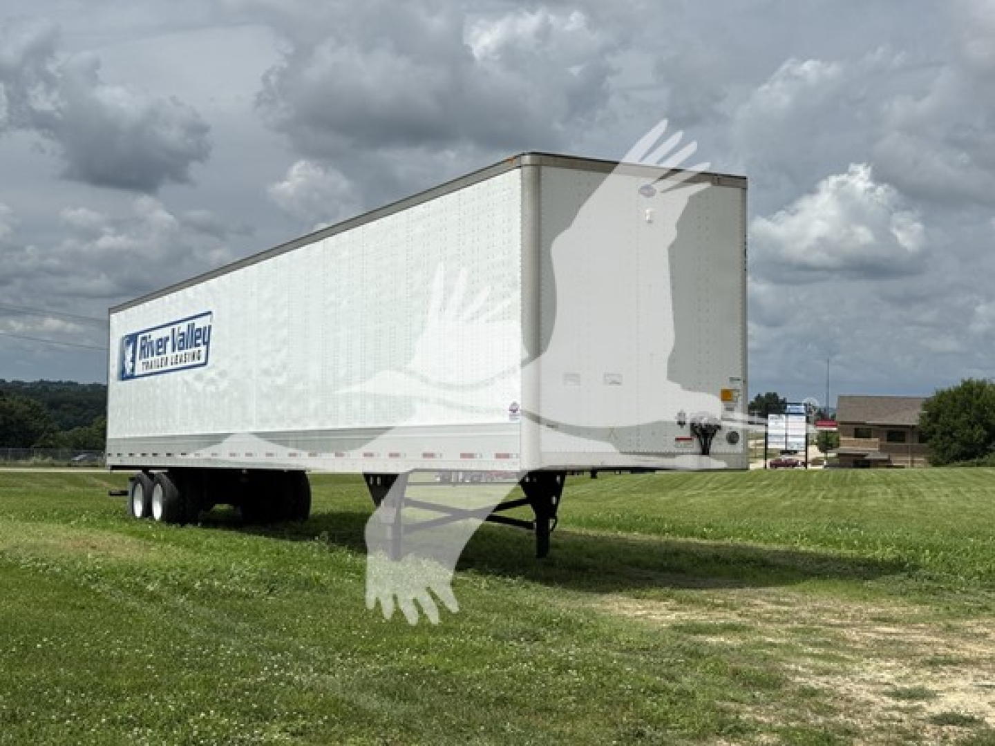 Utility 4000D-X trailer with River Valley Transportation logo on side, white box body, multiple axles, parked on grass.