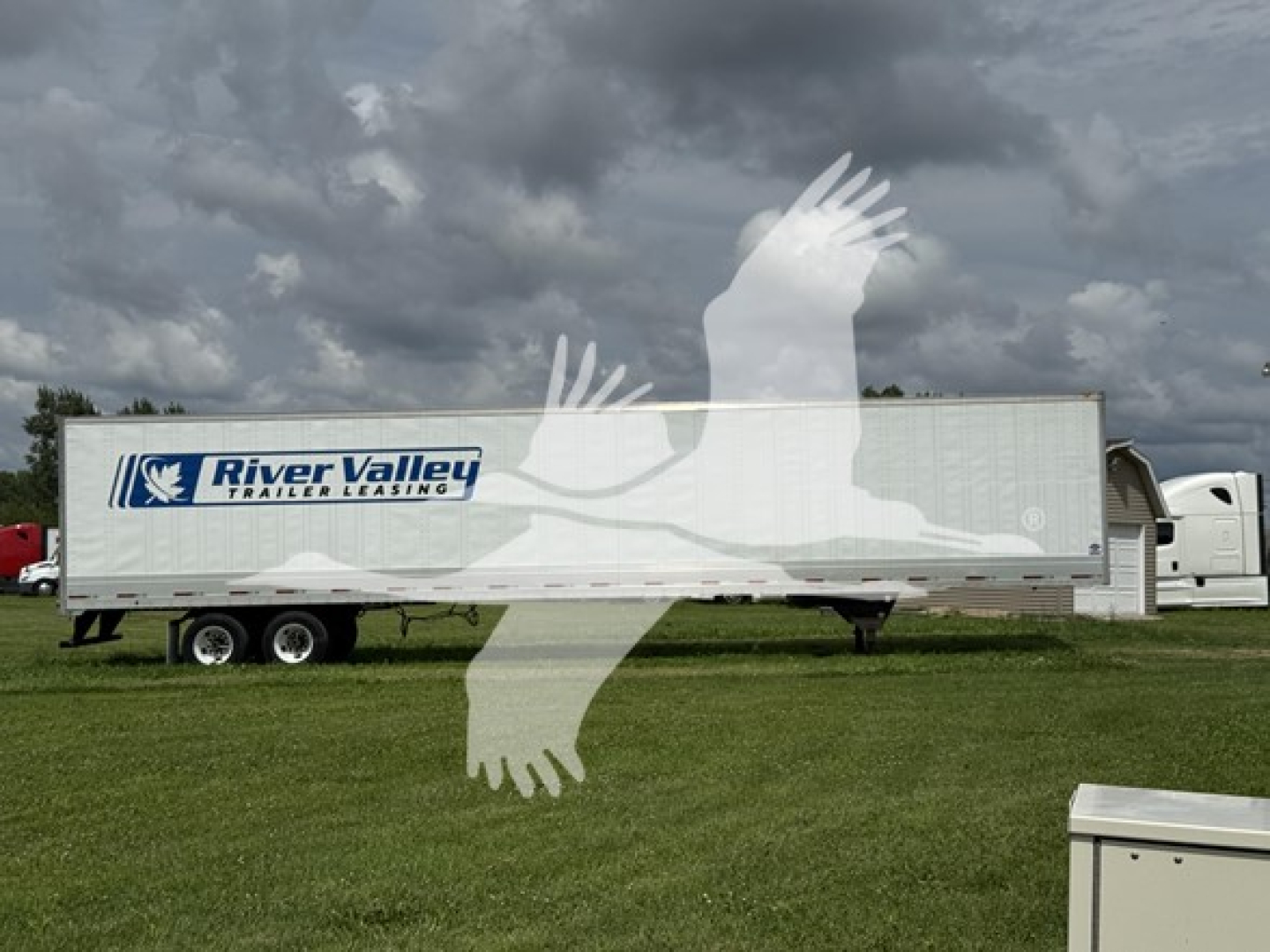 Trailer side showing River Valley Trailers Leasing logo on a long utility trailer.