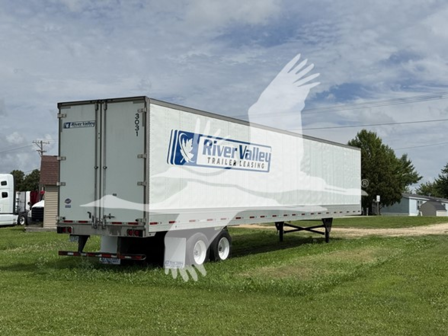 Used 2023 Utility 4000D-X trailer in a grassy lot, white with River Valley Trailer Leasing logo, side view showing dual rear axles and landing gear.