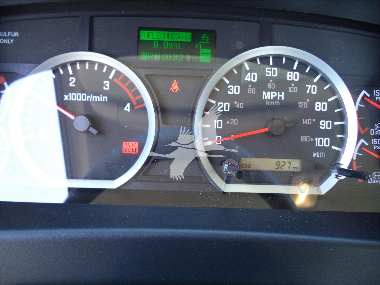 Dashboard view of a 2025 Isuzu FTR rollback truck showing speedometer, tachometer, and center digital display with green status readouts.
