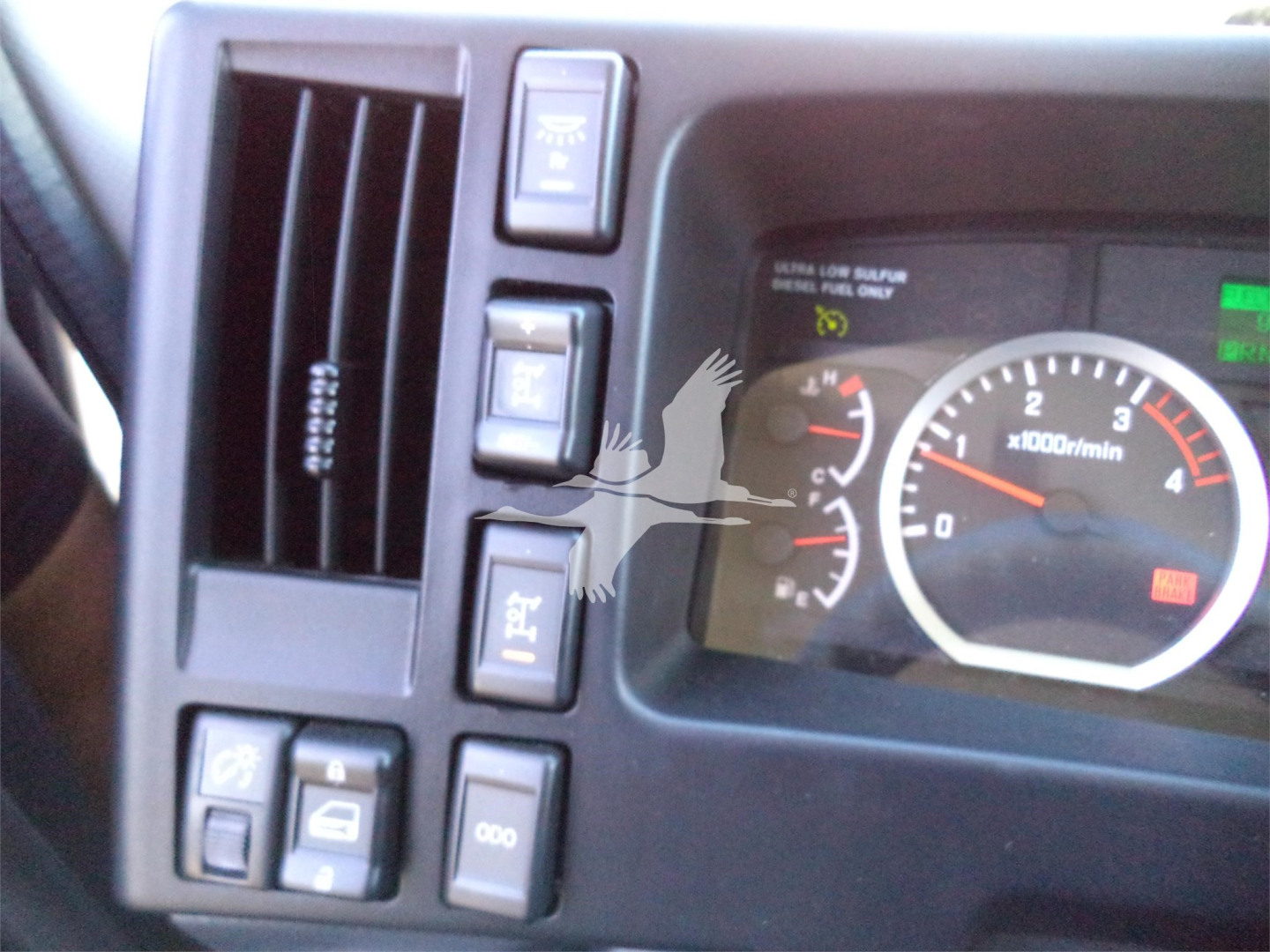Dashboard and instrument cluster of a pickup truck cab showing gauges and control switches.