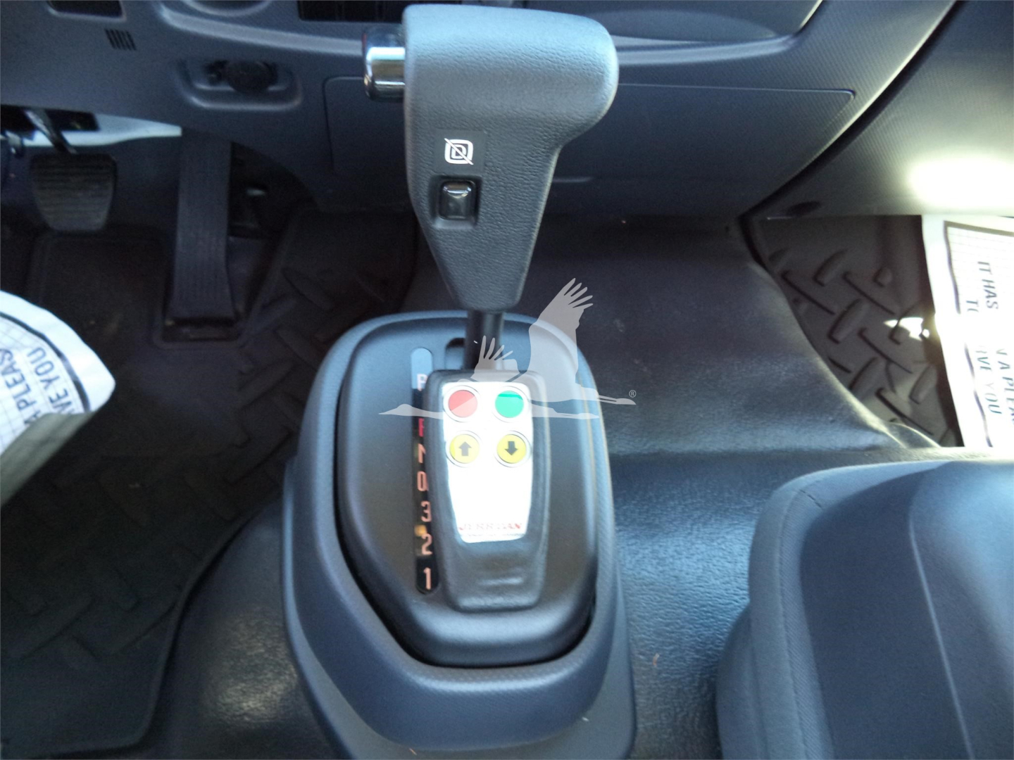 Isuzu FTR truck interior showing automatic shifter with gear indicators and control buttons.