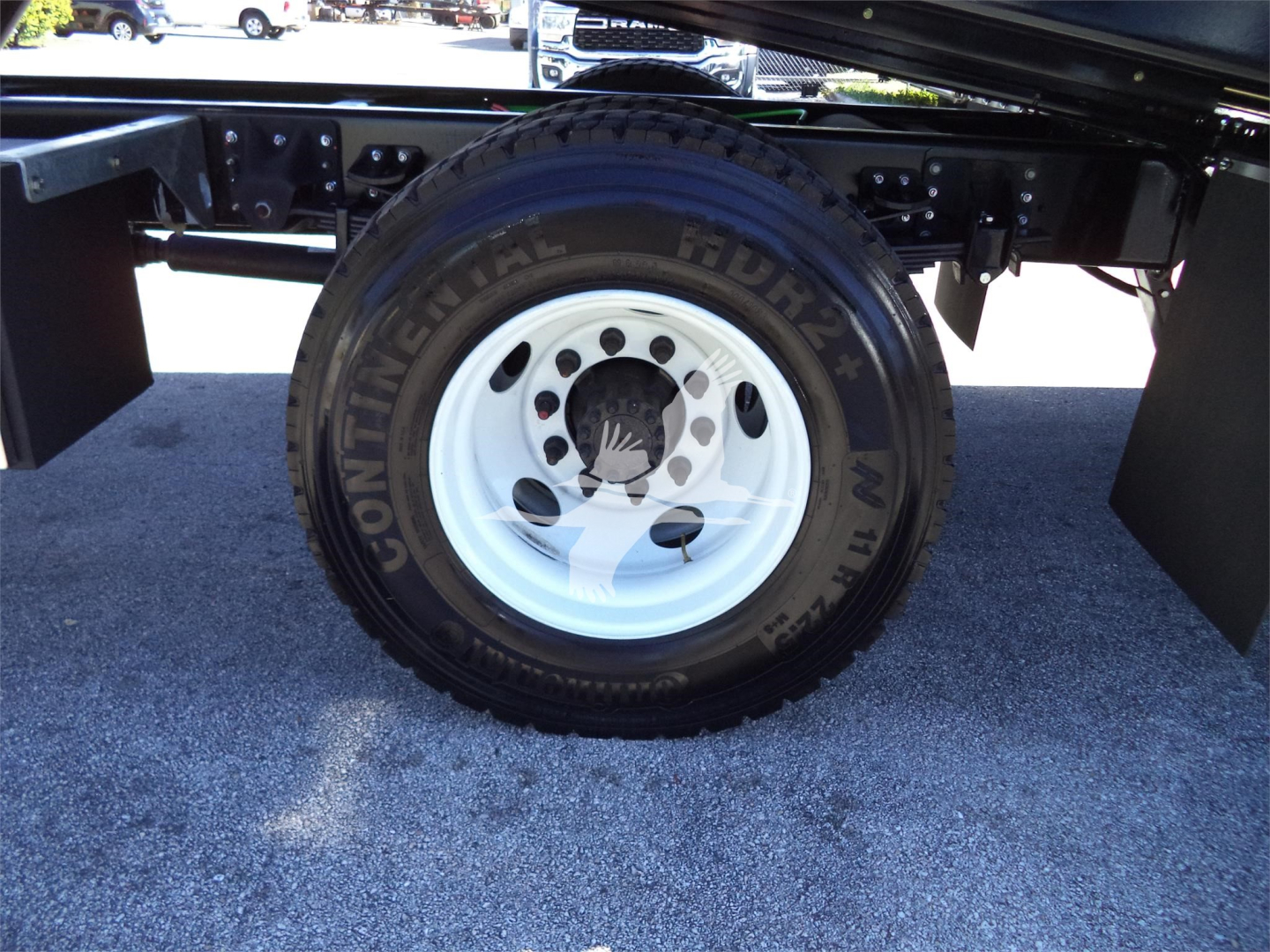 Isuzu FTR rollback truck rear wheel with steel rim and Continental HND tire showing undercarriage frame components.