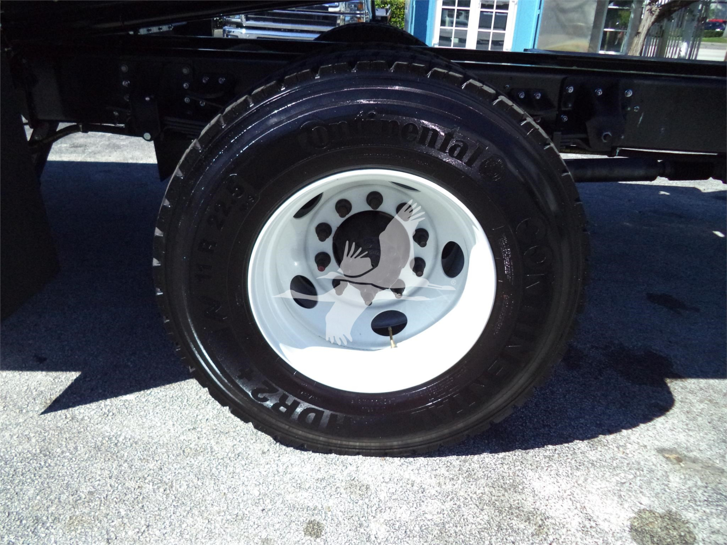 Isuzu FTR rollback truck wheel with tire and white rim, visible label 'Continental' on the tire sidewall.