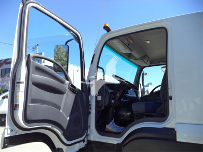 Isuzu FTR cab interior and open driver door showing dashboard and seating area.