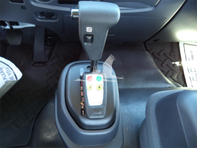 Isuzu FTR truck interior showing automatic shifter with gear indicators and control buttons.
