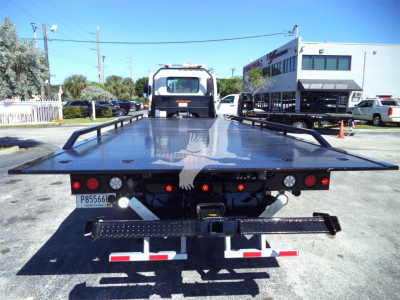 Isuzu FTR rollback bed of tow truck viewed from rear with platform extended.