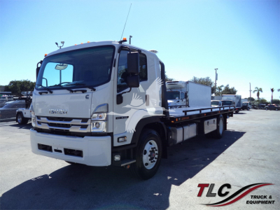 Isuzu FTR rollback truck shown from left front side with flatbed in dealership lot.
