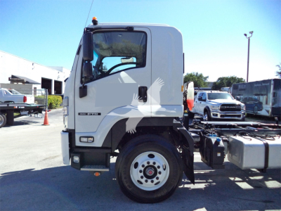 Isuzu FTR rollback truck cab side view showing front wheel, door, and side mirror. Visible text includes ISUZU and FTR model badge on cab.