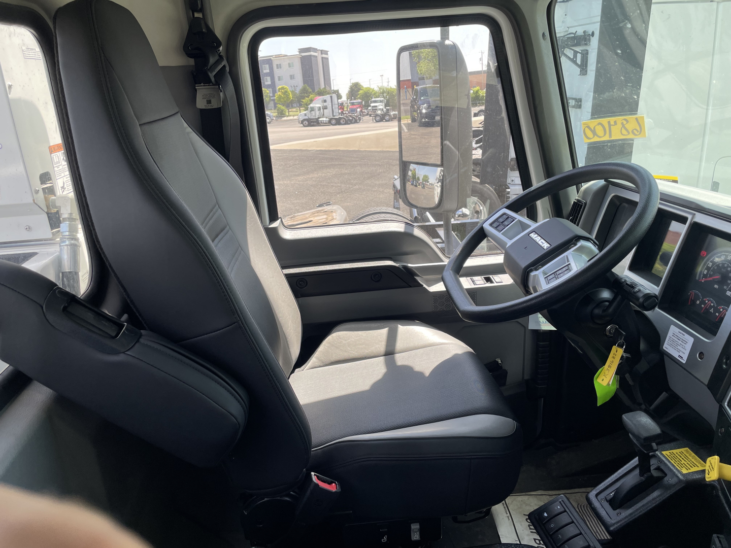Truck cab interior showing driver's seat and steering wheel of a new 2026 Mack MD6.