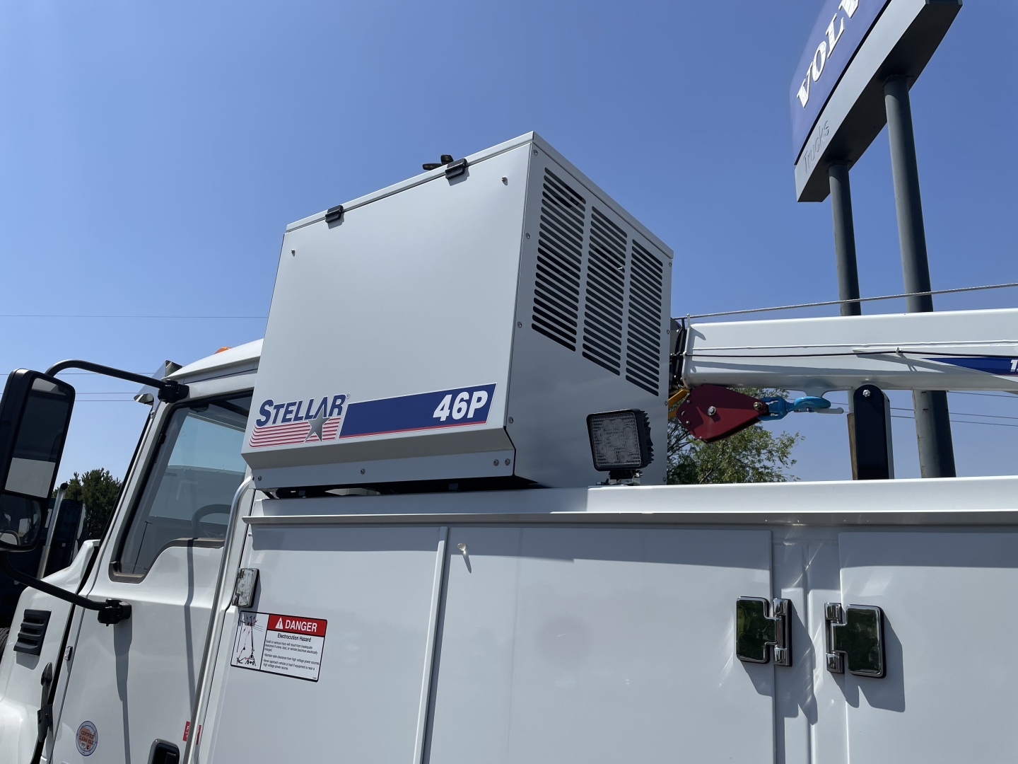 Engine bay area showing a Stellar 46P portable air compressor unit mounted on a white Mack MD6 service truck body.